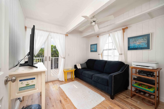 living room featuring french doors, ceiling fan, beam ceiling, and light hardwood / wood-style flooring