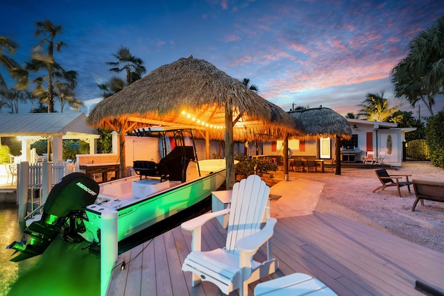 deck at dusk with a gazebo and grilling area