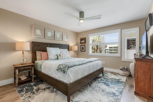 bedroom with hardwood / wood-style floors and ceiling fan