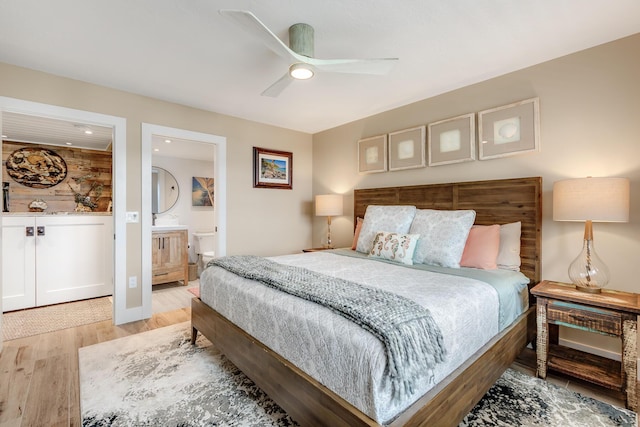 bedroom with ceiling fan, light hardwood / wood-style floors, and ensuite bath