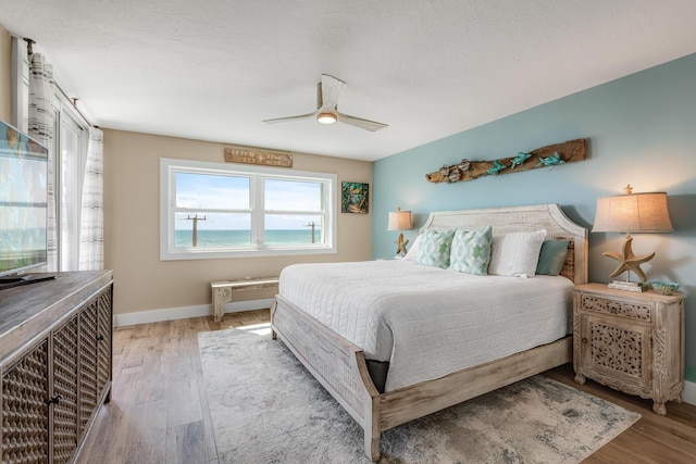 bedroom featuring ceiling fan and light hardwood / wood-style flooring