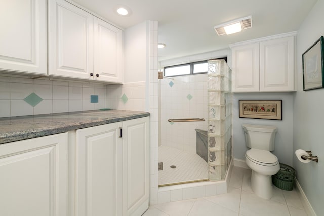 6301 Gulf Of Mexico Blvd Unit 301, Marathon, FL 33050 - bathroom featuring a stall shower, baseboards, decorative backsplash, toilet, and tile patterned flooring