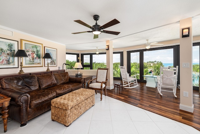 6301 Gulf Of Mexico Blvd Unit 301, Marathon, FL 33050 - living room featuring baseboards, ornamental molding, light tile patterned flooring, and a water view