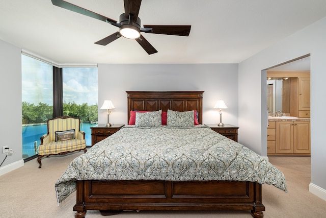 6301 Gulf Of Mexico Blvd Unit 301, Marathon, FL 33050 - bedroom with baseboards, a ceiling fan, light colored carpet, ensuite bathroom, and access to exterior