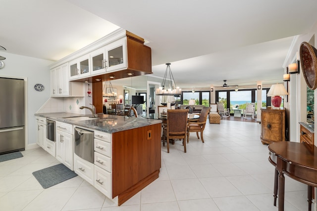 6301 Gulf Of Mexico Blvd Unit 301, Marathon, FL 33050 - kitchen featuring dark stone counters, glass insert cabinets, white cabinets, and freestanding refrigerator