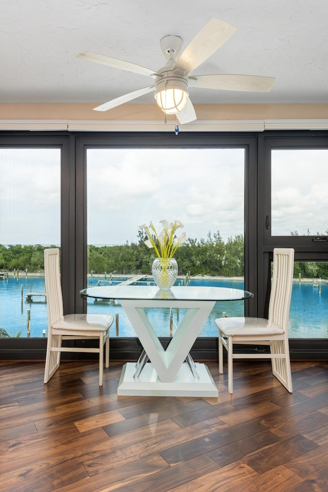 6301 Gulf Of Mexico Blvd Unit 301, Marathon, FL 33050 - unfurnished dining area featuring a water view, plenty of natural light, and dark wood finished floors