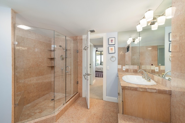 6301 Gulf Of Mexico Blvd Unit 301, Marathon, FL 33050 - ensuite bathroom with visible vents, a stall shower, connected bathroom, vanity, and tile patterned flooring