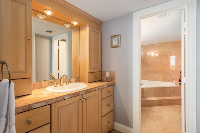 6301 Gulf Of Mexico Blvd Unit 301, Marathon, FL 33050 - bathroom with tiled bath, visible vents, baseboards, tile patterned floors, and vanity