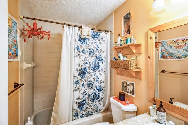 bathroom with vanity, toilet, shower / bath combo with shower curtain, and a textured ceiling