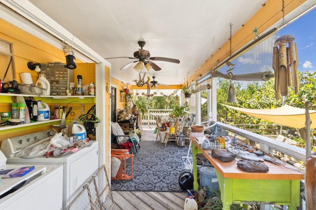 sunroom featuring separate washer and dryer and ceiling fan