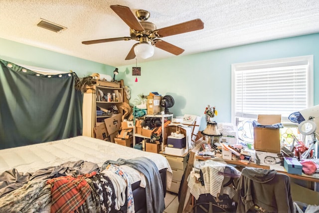 bedroom with visible vents, a textured ceiling, and ceiling fan