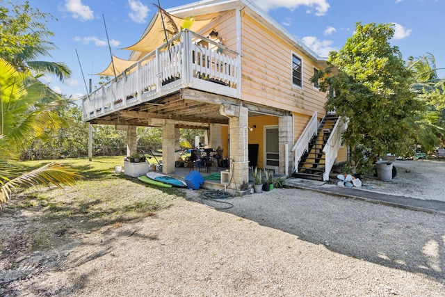 back of house with a patio area, stairs, and a deck