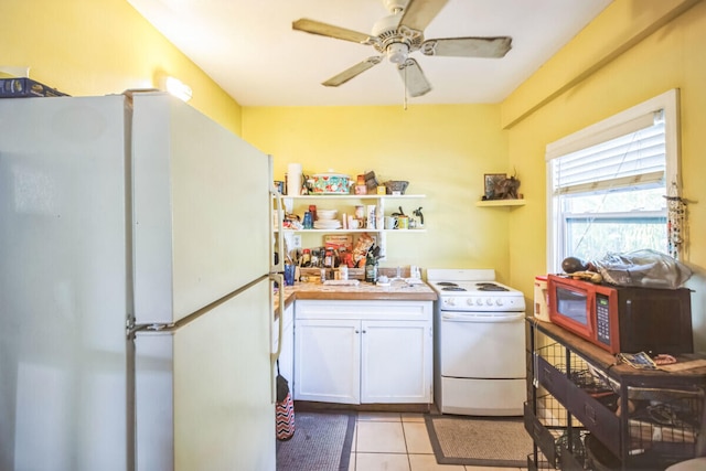 laundry room featuring laundry area, light tile patterned flooring, and ceiling fan