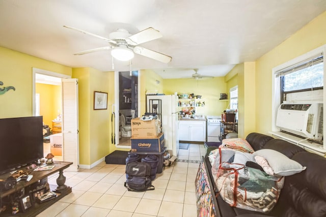 living room with tile patterned floors, cooling unit, baseboards, and ceiling fan