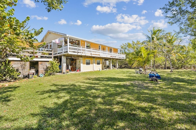 back of property with a yard and a deck