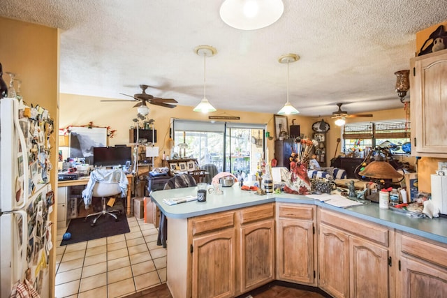 kitchen with a peninsula, a ceiling fan, open floor plan, and a wealth of natural light