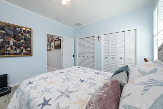 bedroom featuring multiple closets and ceiling fan