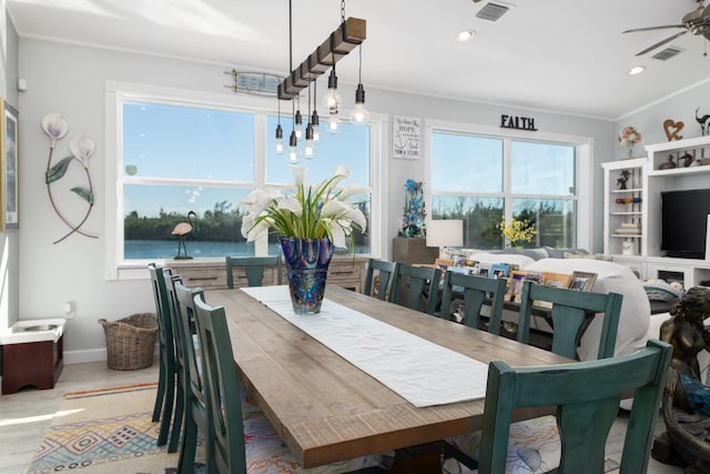 dining area with crown molding, ceiling fan, and light hardwood / wood-style floors