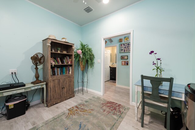 office area with light hardwood / wood-style flooring, ornamental molding, and ceiling fan