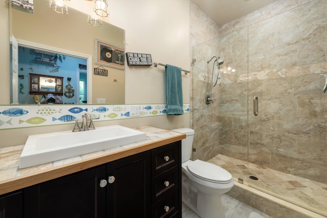 bathroom featuring vanity, toilet, and an enclosed shower