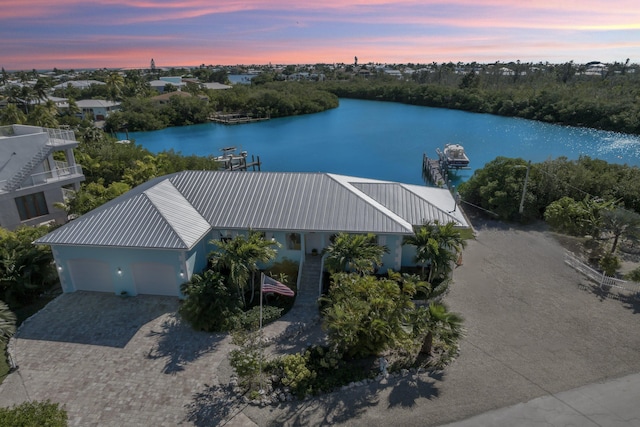 aerial view at dusk with a water view