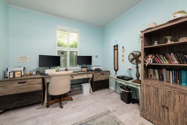 office area with crown molding and light hardwood / wood-style floors