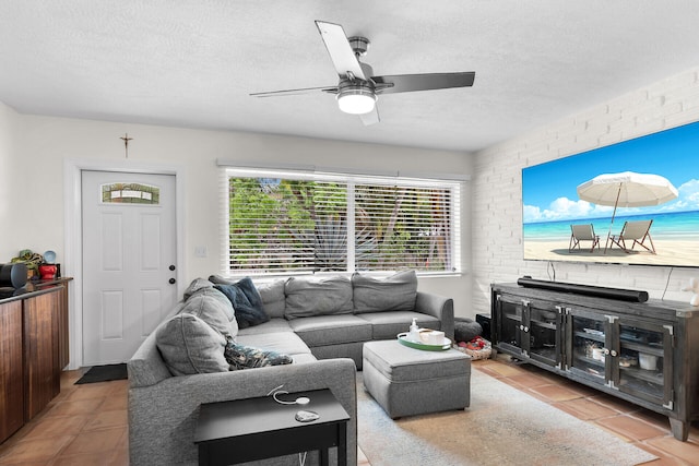 living room with light tile patterned floors, a textured ceiling, and ceiling fan