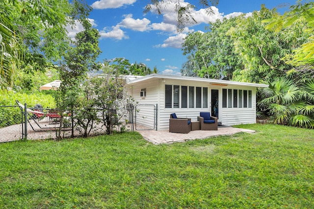 back of house with a yard, outdoor lounge area, and a patio