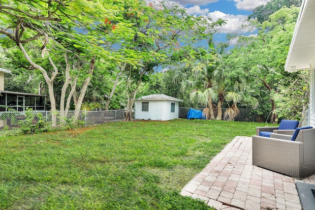 view of yard featuring a storage shed and a patio area