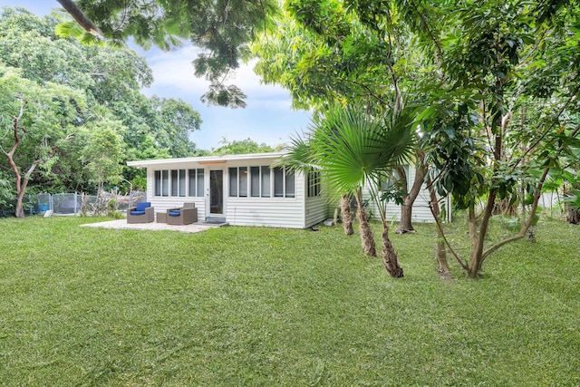 exterior space with a sunroom and a patio area