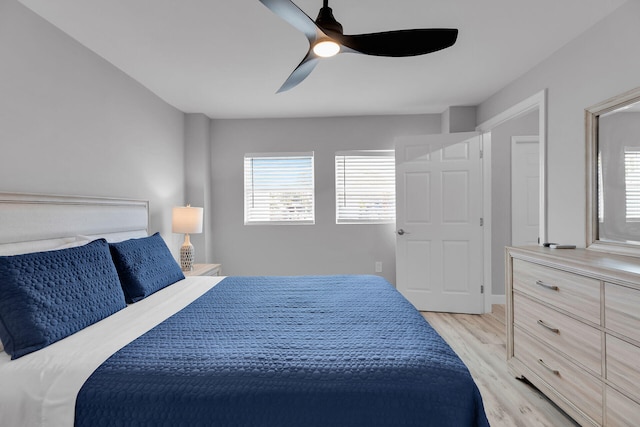 bedroom featuring multiple windows, light wood-style floors, and a ceiling fan