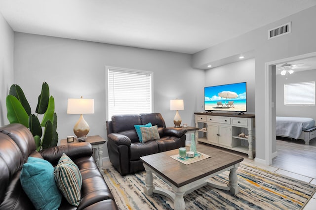 living room with recessed lighting, a ceiling fan, and baseboards