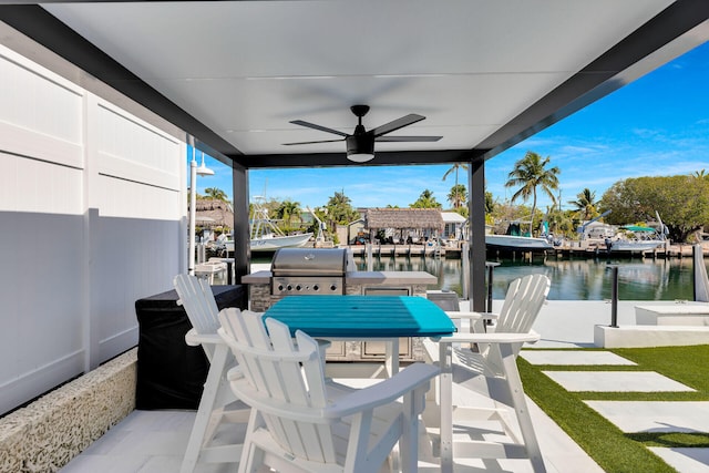 view of patio featuring grilling area, a water view, a ceiling fan, a boat dock, and outdoor dining area