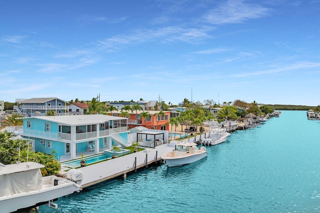 dock with a water view, a community pool, and a residential view