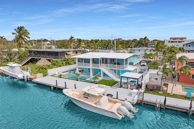 dock area featuring a community pool, boat lift, a patio area, stairs, and a water view