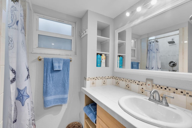 bathroom featuring tasteful backsplash, a shower with shower curtain, and vanity
