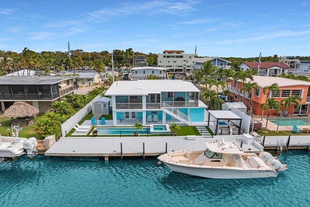 drone / aerial view of a pool area and a large body of water