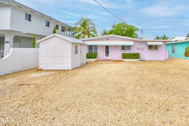 263 Azalea St, Tavernier, FL 33070 - back of house with a storage shed and stucco siding
