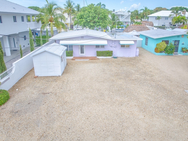 263 Azalea St, Tavernier, FL 33070 - view of front facade with a storage shed and a residential view