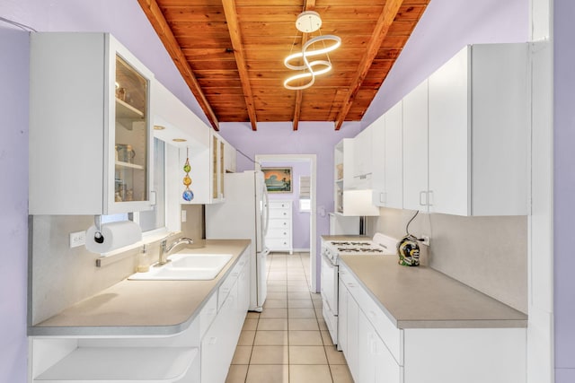263 Azalea St, Tavernier, FL 33070 - kitchen featuring white appliances, a wood ceiling with exposed beams, light tile patterned floors, white cabinetry, and light countertops