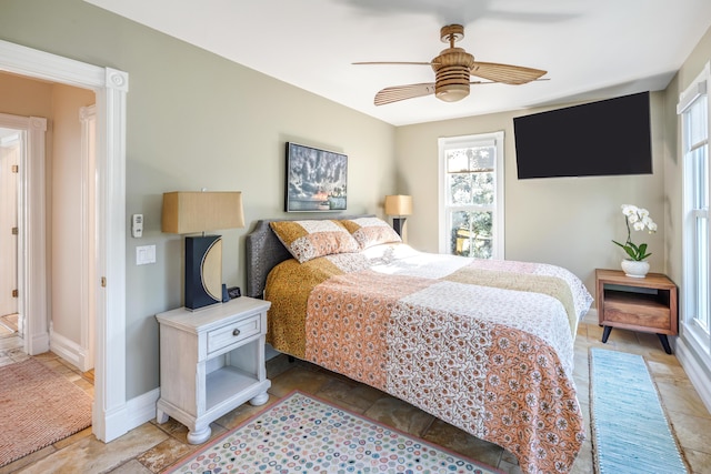 bedroom featuring a ceiling fan and baseboards