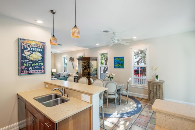 kitchen with recessed lighting, a sink, visible vents, open floor plan, and pendant lighting