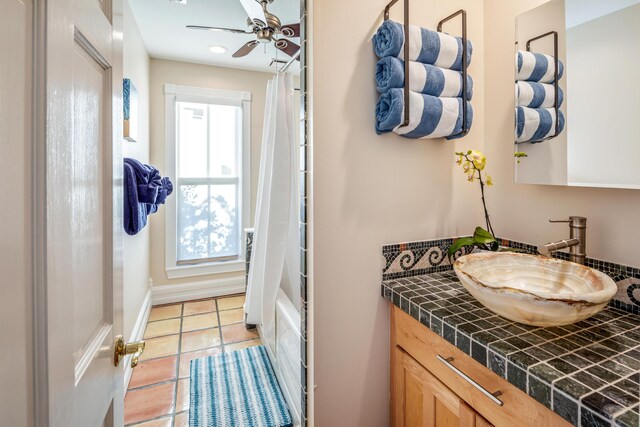 bathroom featuring tile patterned flooring, plenty of natural light, a ceiling fan, and shower / bath combination with curtain