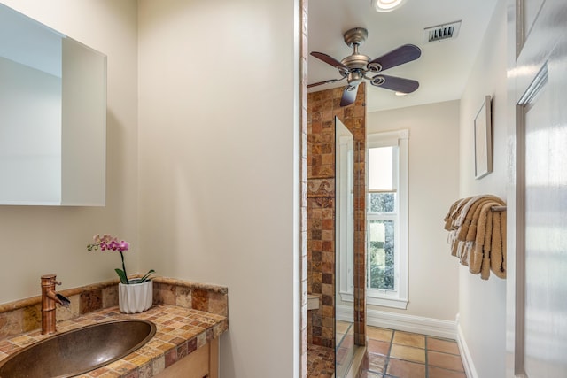 bathroom with visible vents, a ceiling fan, vanity, tile patterned flooring, and baseboards