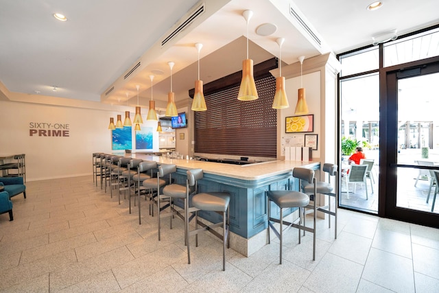 bar with floor to ceiling windows and pendant lighting