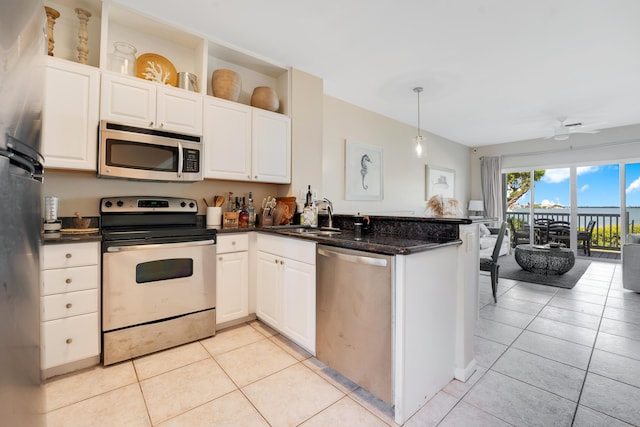 kitchen with stainless steel appliances, sink, white cabinets, and kitchen peninsula