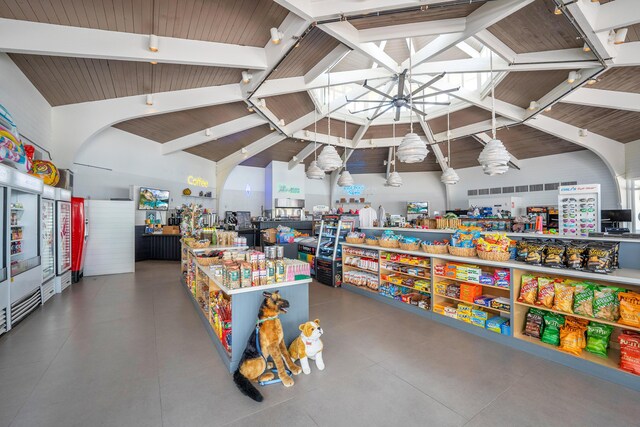 misc room with high vaulted ceiling and beam ceiling