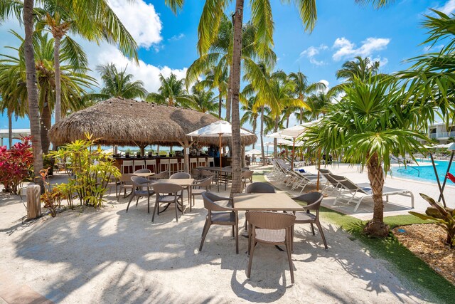 view of patio / terrace with a gazebo, a community pool, and an outdoor bar