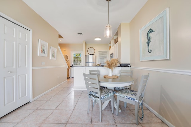 dining area with light tile patterned floors