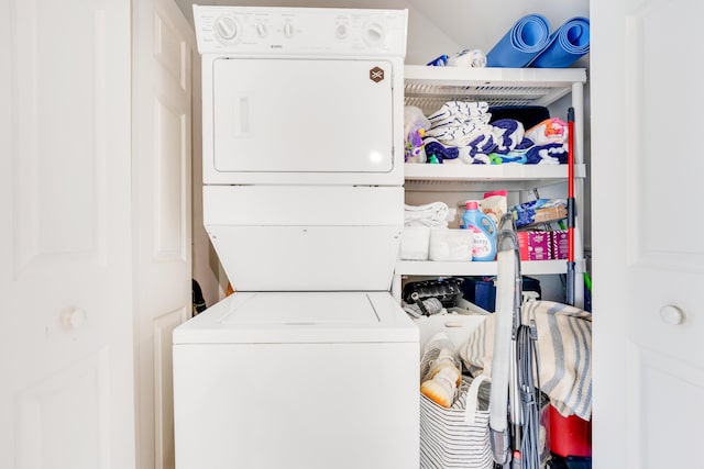 laundry area featuring stacked washer / drying machine